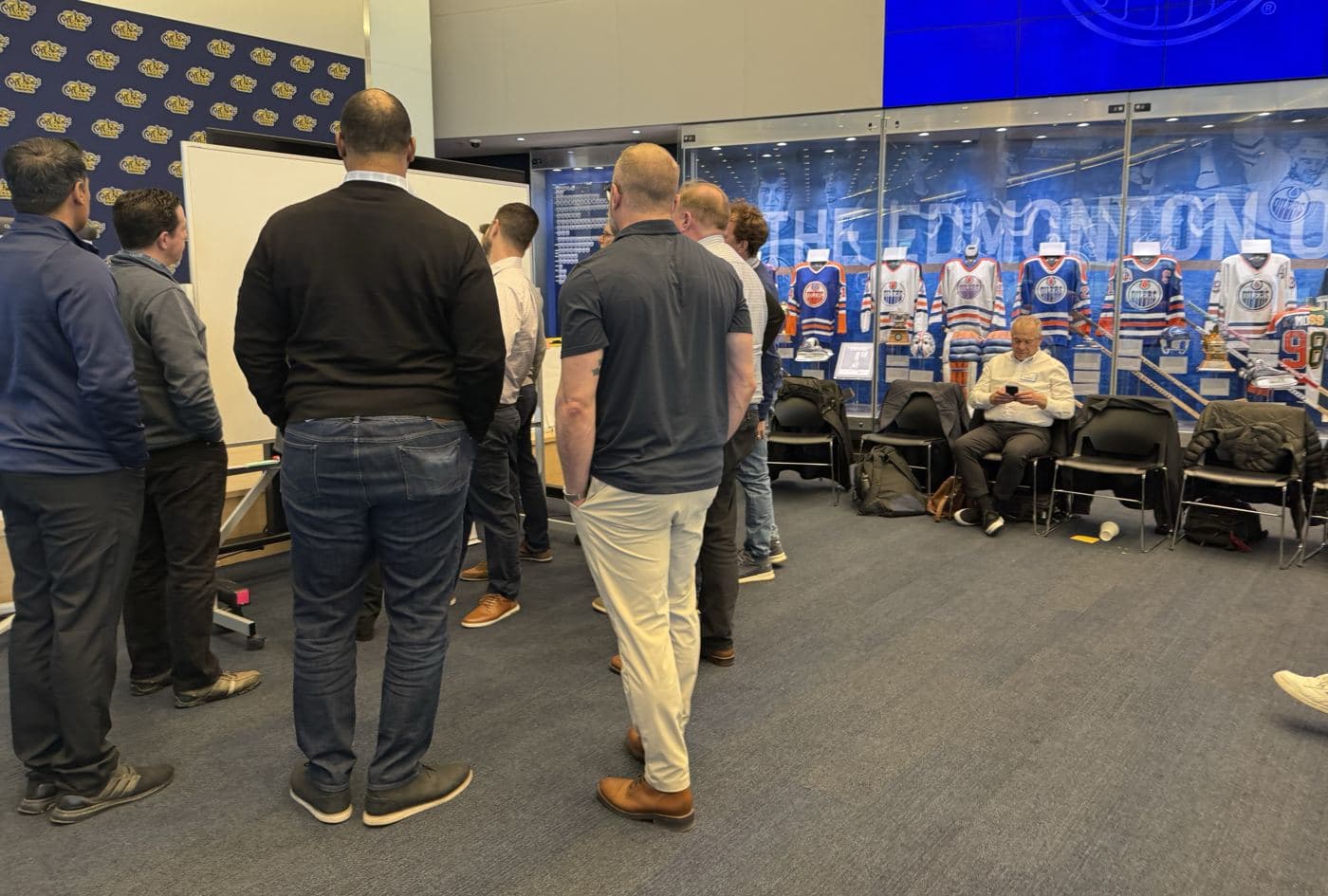 A group of leaders standing back from a whiteboard map, looking at it together