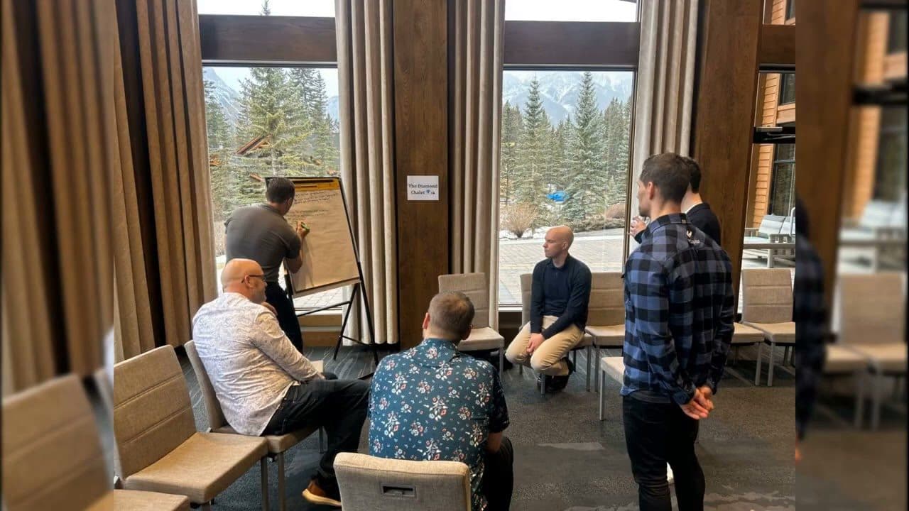 Video still of a small group in an Open Space breakout at the Canmore retreat